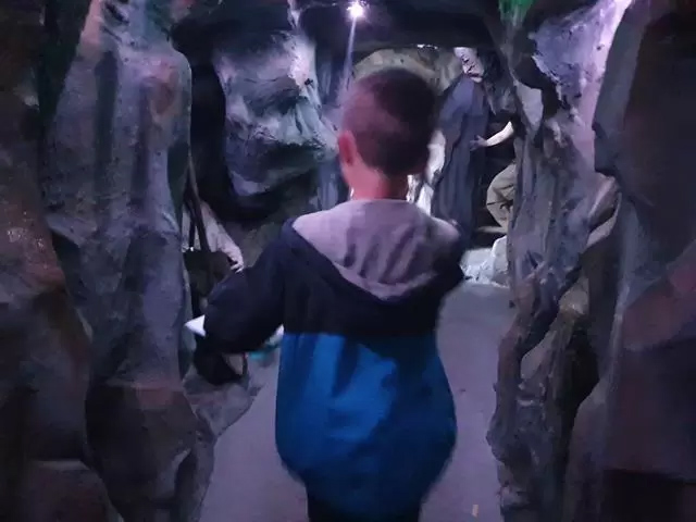 Child walking through simulated graphic mine entrance at Derwent Pencil Museum.