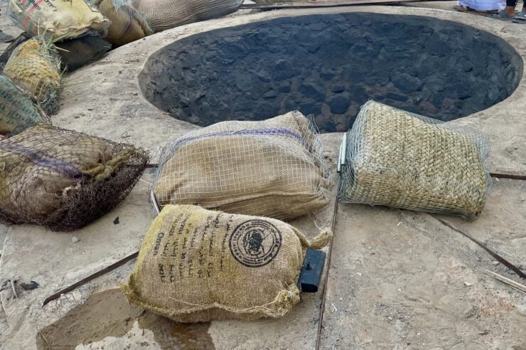 flavors of Oman - five shuwa bags lay outside the shuwa pit
