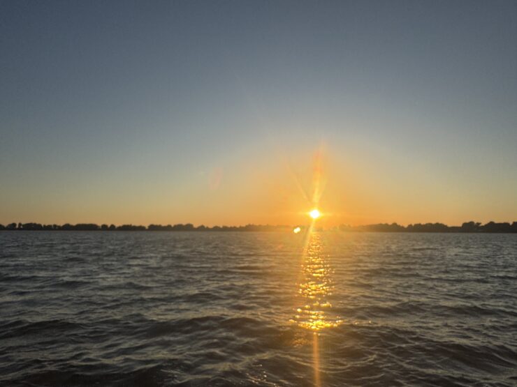 Sunset over a wide body of water