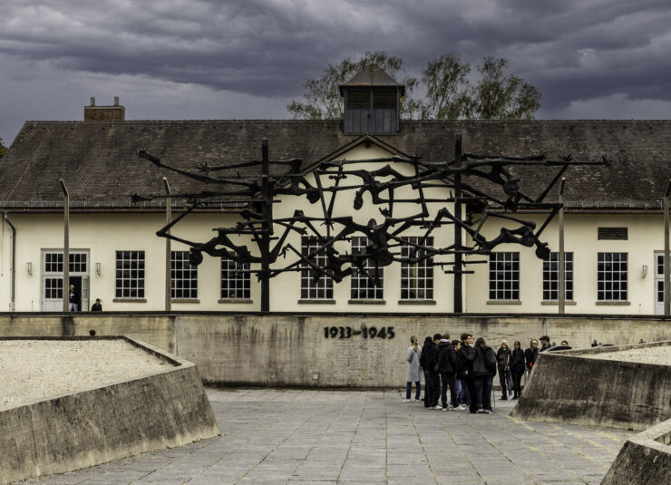 Sculpture with human figures entangled in barbed wire at Dachau