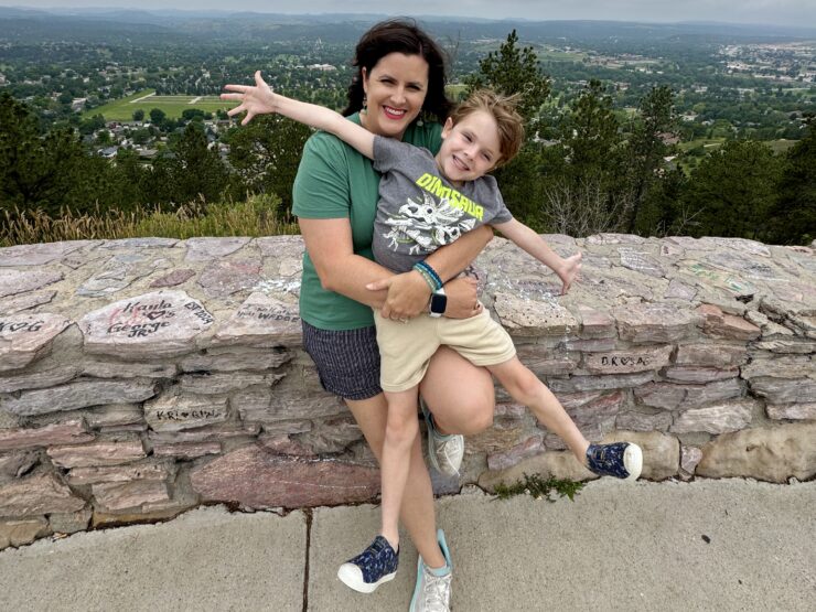 A mother and son pose for photos on a Rapid City family vacation.