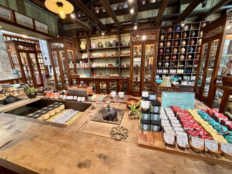 Tea pots and tea in a tea shop with shelves and tables filled with everything to make a cup of tea.