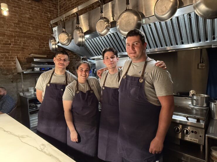 A group of chefs in the food preparation area at ARVI in Limoilou.