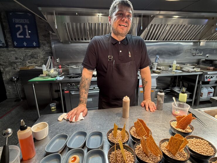 Chef Stéphan Modet speaks with guests from the open kitchen of Le Clan in Old Quebec.