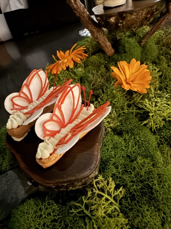 Dessert that shows pastry butterflies with orange wings.