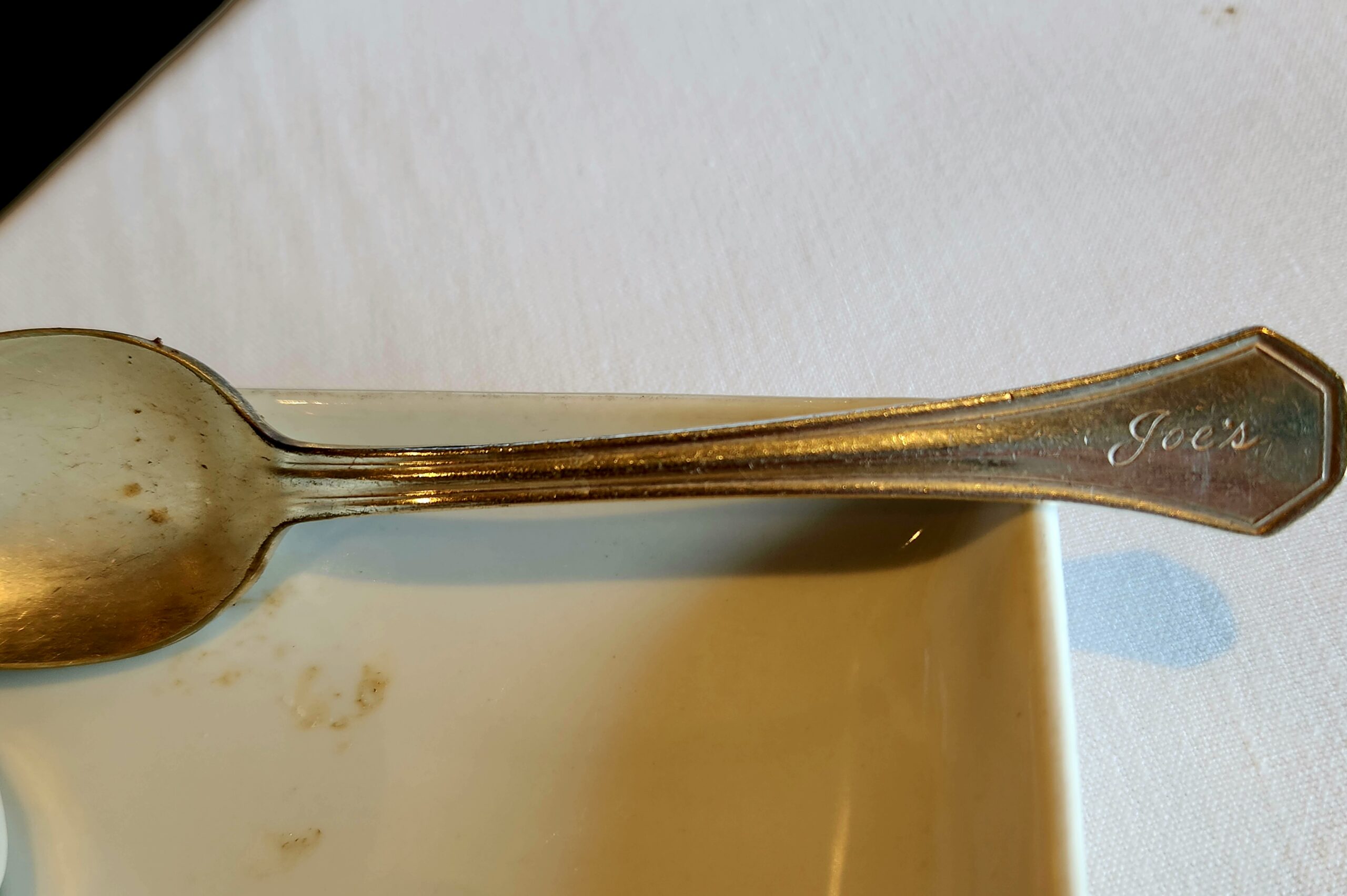 A spoon, engraved on the end with "Joe's"