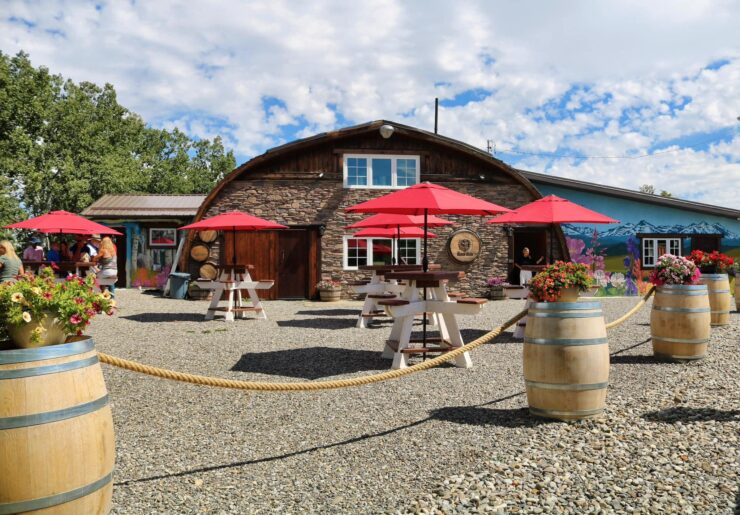 Spirit Hills Winery, showing barrels, tables and umbrellas outside the tasting room building.