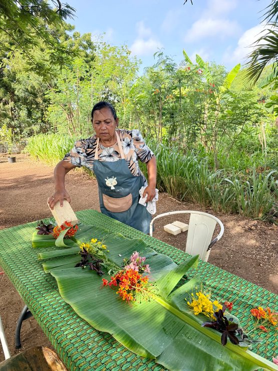 Chef Rositta Bakri setting table with flowers from her garden at Nature Cooking School Bonaire.