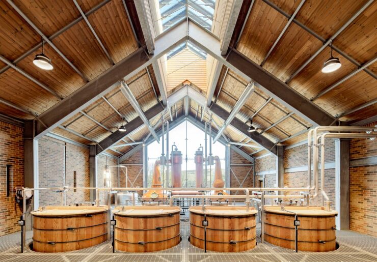 Wooden barrels in open plan warehouse with large windows