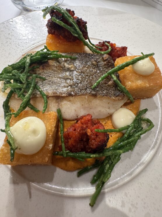 Ceramic plate of fish, patatas braves, samphire and ndjua